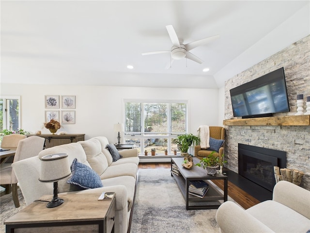 living area with recessed lighting, plenty of natural light, wood finished floors, and a fireplace