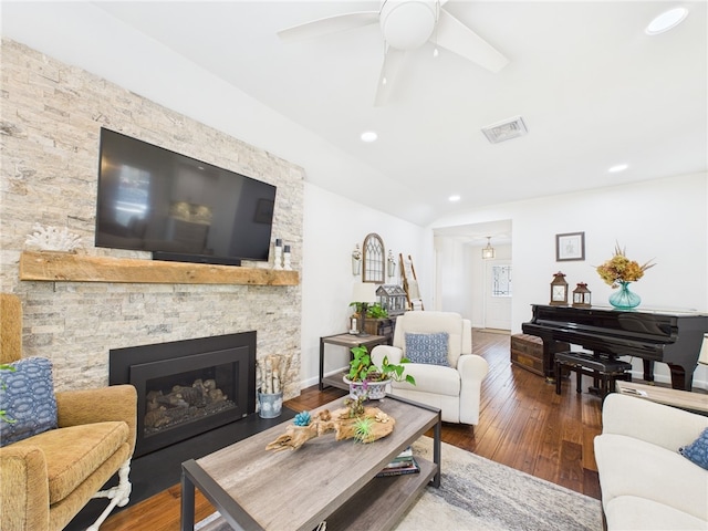 living room featuring visible vents, lofted ceiling, recessed lighting, a fireplace, and wood-type flooring