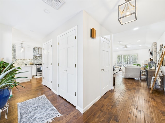 hall with recessed lighting, visible vents, dark wood-style flooring, and baseboards