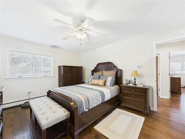 bedroom with visible vents, ceiling fan, baseboards, baseboard heating, and dark wood-style floors