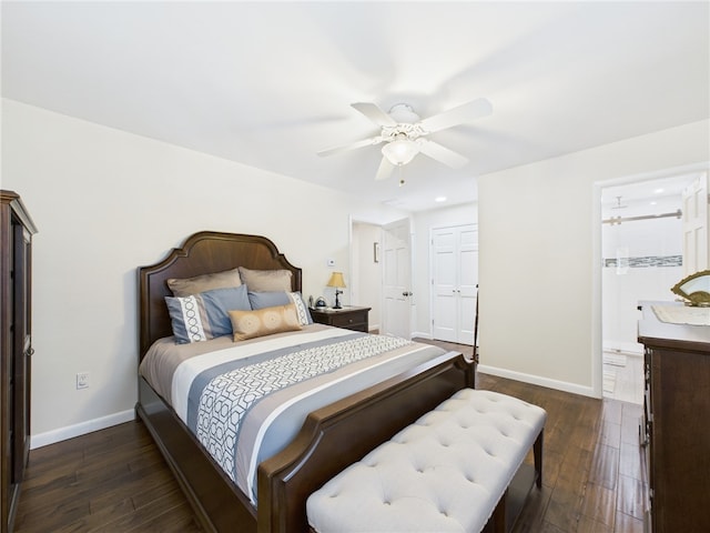 bedroom featuring dark wood-type flooring, baseboards, ensuite bathroom, a closet, and a ceiling fan