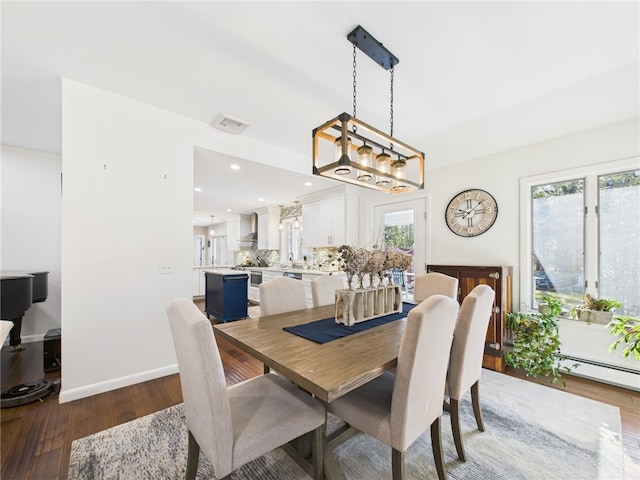 dining area with visible vents, wood-type flooring, plenty of natural light, and baseboards