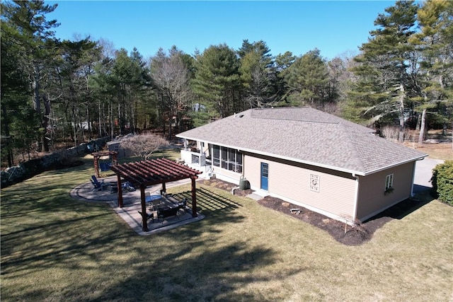 back of house with a lawn, a shingled roof, and a pergola