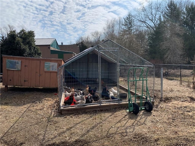 view of poultry coop featuring fence