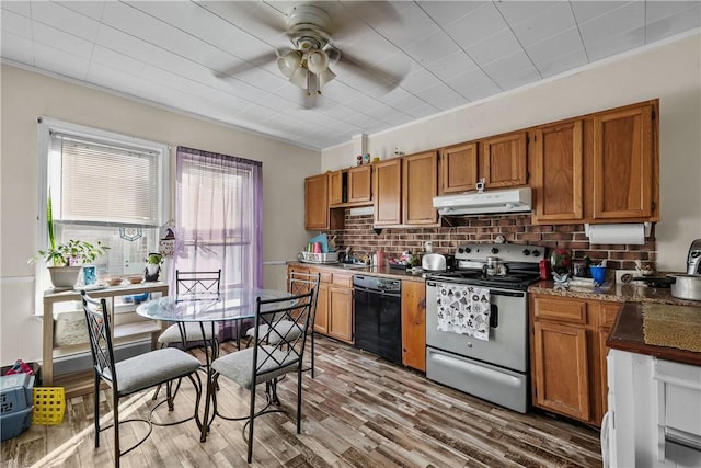 kitchen featuring wood finished floors, electric range, under cabinet range hood, dishwasher, and brown cabinets