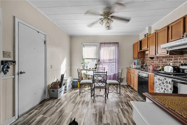 kitchen with wood finished floors, electric stove, under cabinet range hood, dishwasher, and brown cabinets