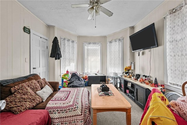 carpeted living room with a textured ceiling and ceiling fan