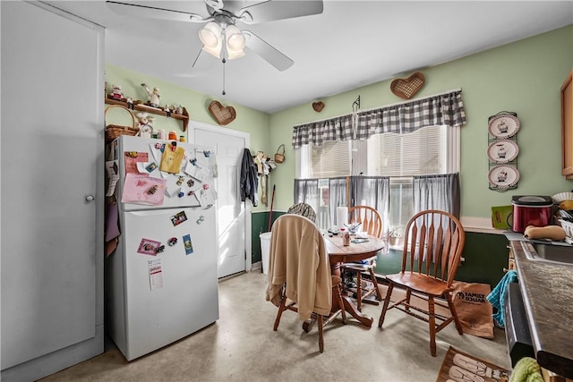 dining room featuring finished concrete flooring and a ceiling fan