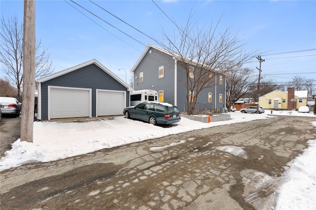 view of front of home featuring a detached garage and an outbuilding