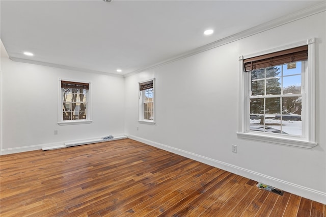 spare room with hardwood / wood-style flooring, recessed lighting, baseboards, and ornamental molding