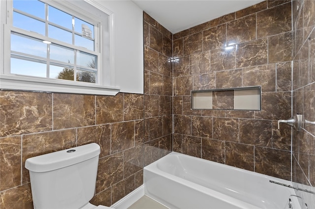 full bath with toilet and tile walls