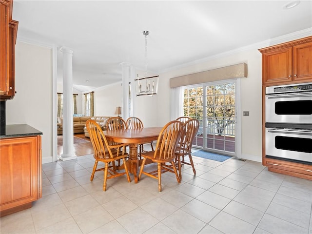 dining area with crown molding, decorative columns, light tile patterned floors, and a chandelier