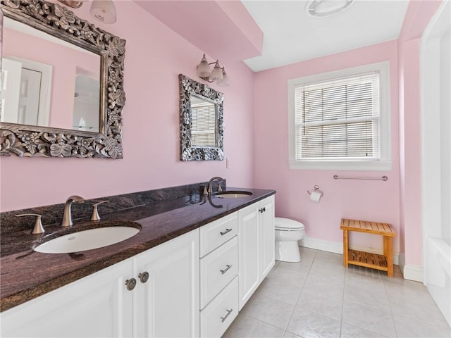 full bathroom with tile patterned flooring, toilet, baseboards, and a sink