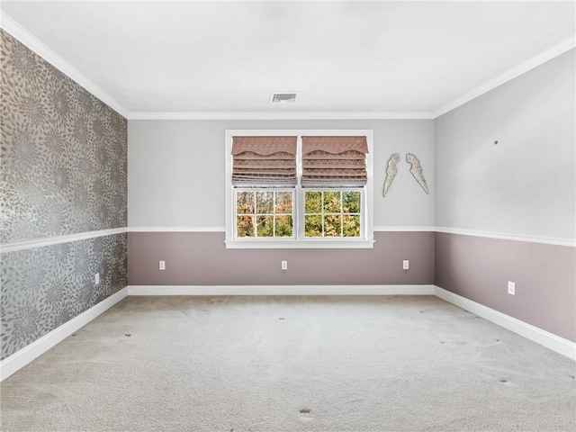 unfurnished room with wallpapered walls, carpet, visible vents, and ornamental molding