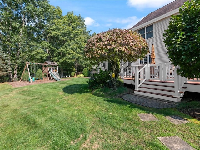 view of yard featuring a deck and a playground