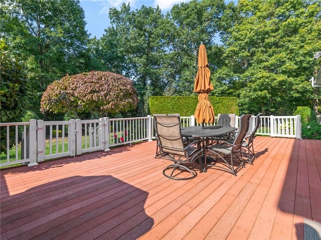 wooden terrace featuring outdoor dining space