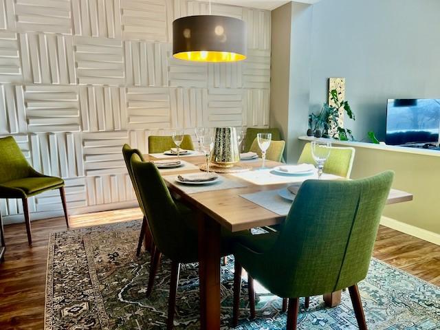 dining room with baseboards and wood finished floors