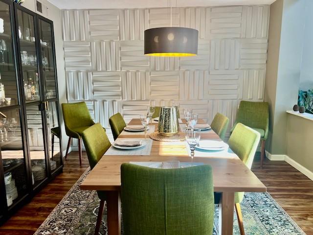 dining space with baseboards and dark wood-style flooring