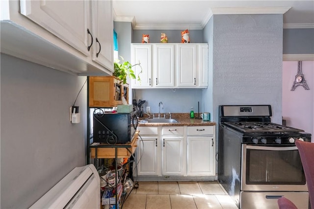 kitchen featuring a sink, crown molding, stainless steel gas range, and white cabinetry