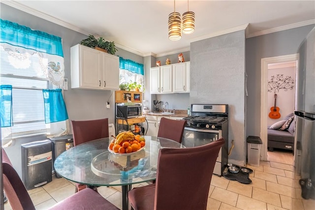 kitchen featuring a sink, stainless steel appliances, white cabinets, and ornamental molding