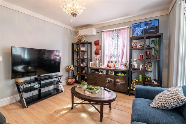 living room featuring a chandelier, baseboards, an AC wall unit, and wood finished floors