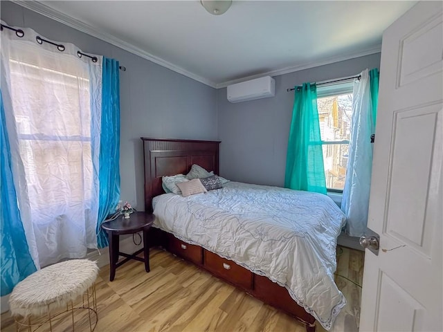 bedroom with a wall unit AC, crown molding, and wood finished floors