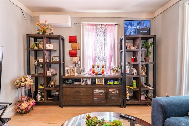 interior space featuring wood finished floors and a wall mounted AC