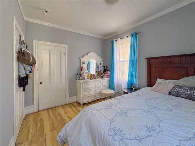 bedroom featuring light wood-type flooring and ornamental molding