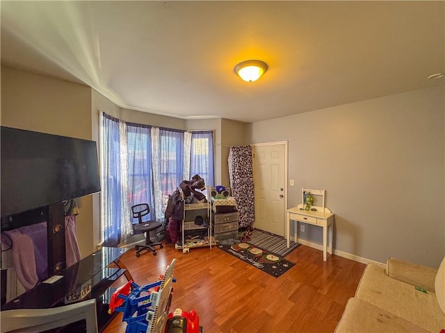 interior space featuring baseboards and wood finished floors