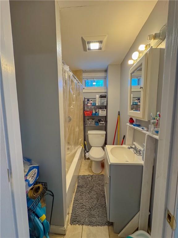 bathroom with a shower with shower curtain, visible vents, toilet, and tile patterned flooring