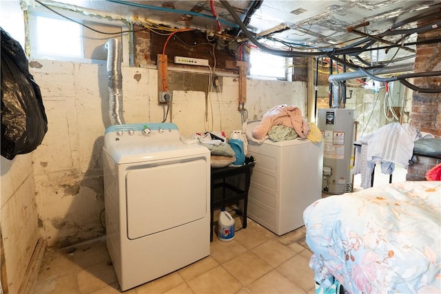 interior space with gas water heater, washing machine and dryer, and laundry area