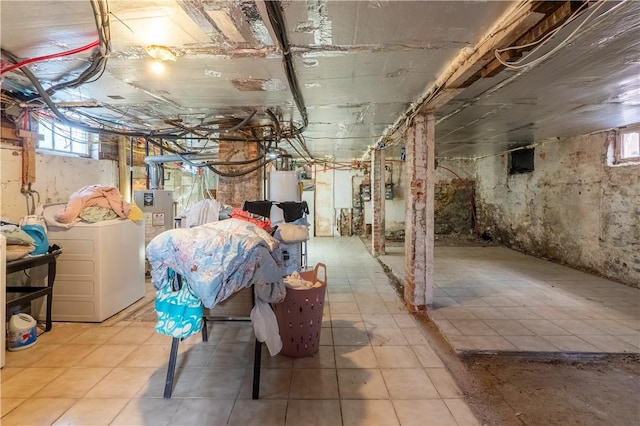 below grade area featuring washing machine and dryer and water heater