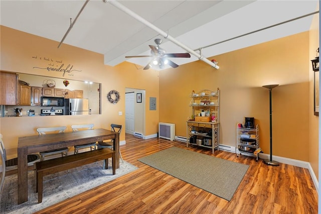 dining space featuring baseboards, beam ceiling, wood finished floors, and a ceiling fan