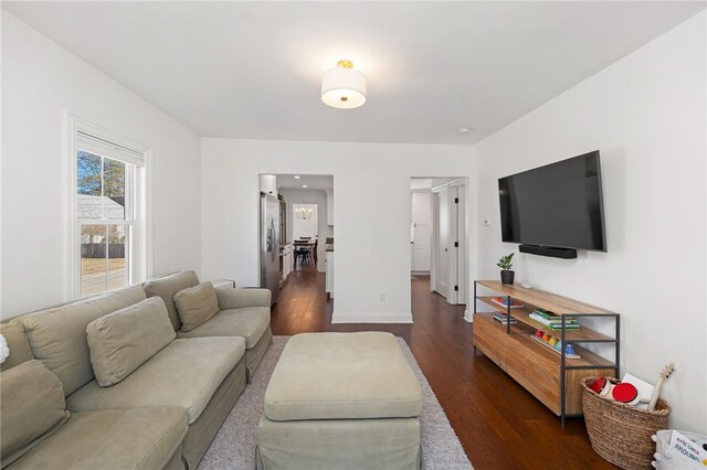 living area featuring dark wood finished floors and baseboards