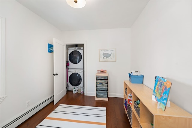 laundry room with stacked washer / dryer, baseboards, a baseboard radiator, laundry area, and dark wood-style flooring