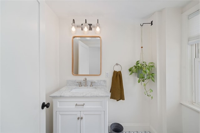 bathroom featuring baseboards and vanity