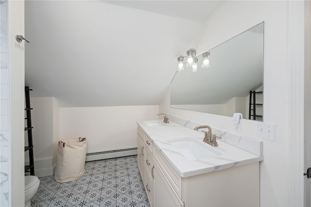 full bathroom featuring a baseboard radiator, toilet, double vanity, vaulted ceiling, and a sink