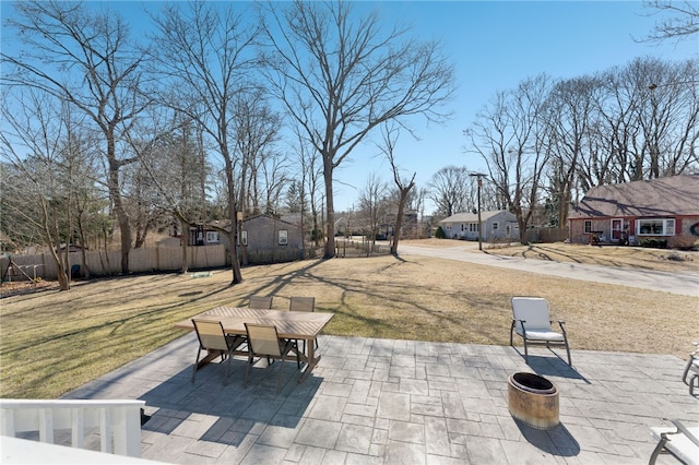 view of patio with a residential view, outdoor dining area, and fence