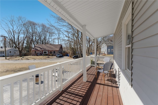 deck with a residential view and covered porch