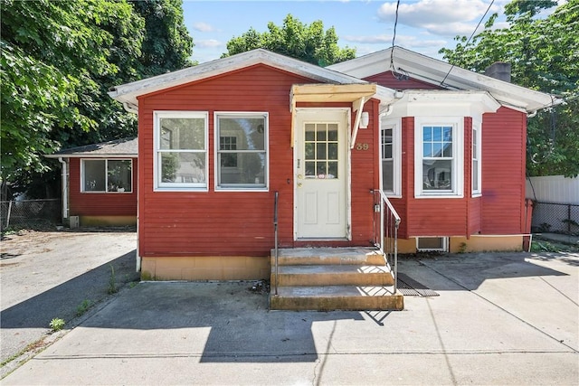 view of outbuilding featuring fence and entry steps