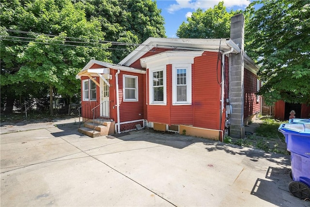 view of outbuilding featuring fence