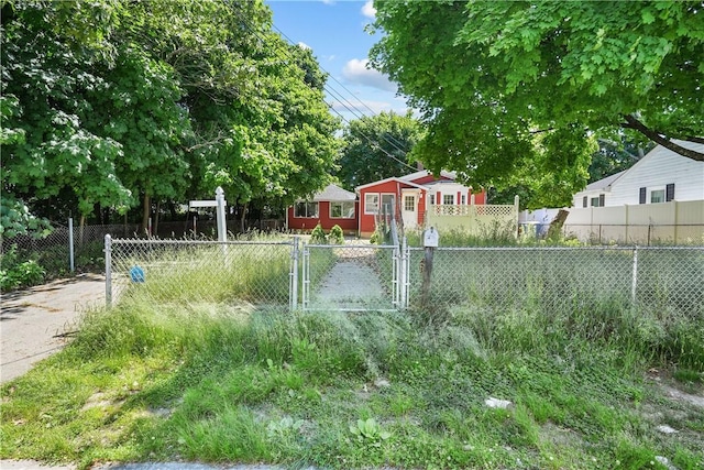 view of yard with a fenced front yard and a gate