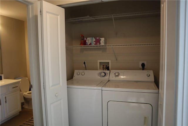 clothes washing area featuring washer and dryer and laundry area