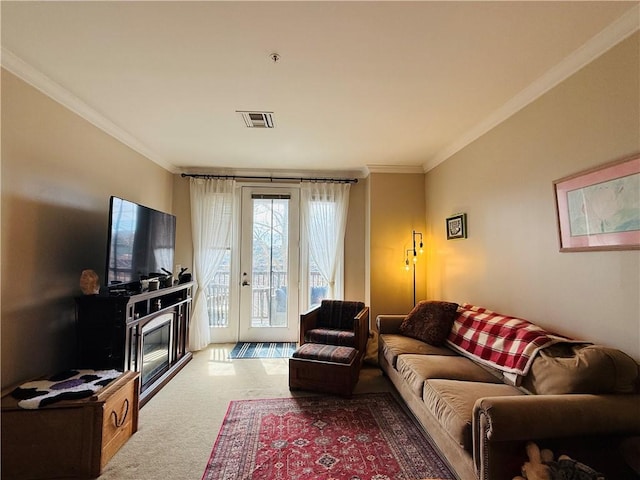 living area with visible vents, carpet flooring, and crown molding