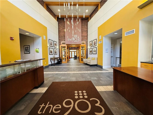 reception area with visible vents and a notable chandelier