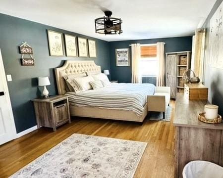 bedroom featuring baseboards and wood finished floors