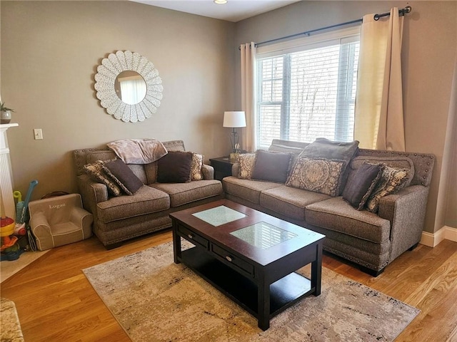 living room with baseboards and light wood finished floors