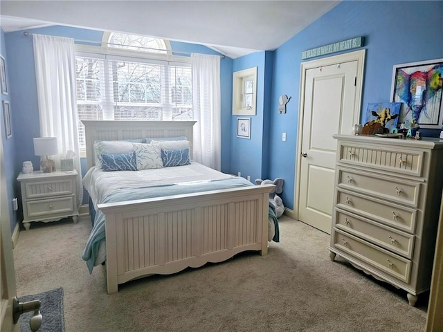 bedroom featuring baseboards, carpet, and vaulted ceiling