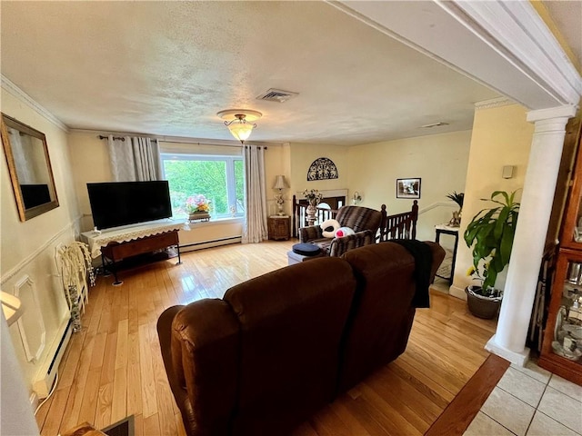 living area with visible vents, a baseboard radiator, light wood-style floors, and decorative columns