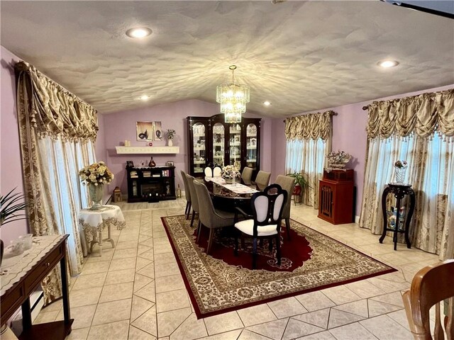 dining room with a textured ceiling, recessed lighting, an inviting chandelier, light tile patterned flooring, and vaulted ceiling